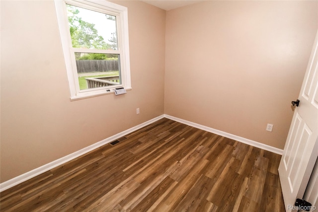 519 S Elm St, Lapeer, MI 48446 - unfurnished room featuring baseboards and dark wood-style floors
