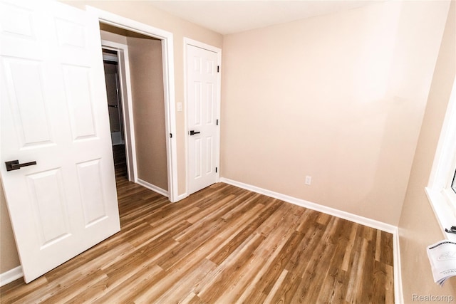 519 S Elm St, Lapeer, MI 48446 - unfurnished bedroom featuring light wood finished floors and baseboards