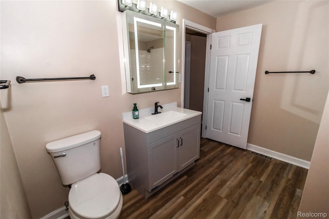 519 S Elm St, Lapeer, MI 48446 - full bath with vanity, wood finished floors, toilet, baseboards, and a shower