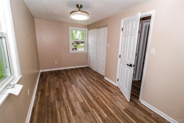 519 S Elm St, Lapeer, MI 48446 - unfurnished bedroom featuring wood finished floors, baseboards, and a closet