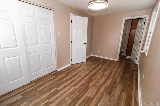 519 S Elm St, Lapeer, MI 48446 - unfurnished bedroom with wood finished floors, baseboards, and a closet