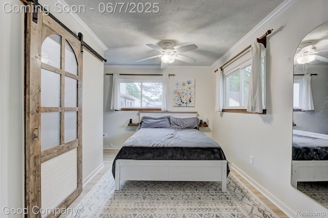 4511 Rosewold Ave, Royal Oak, MI 48073 - bedroom featuring a barn door, crown molding, light wood-style flooring, a textured ceiling, and baseboards