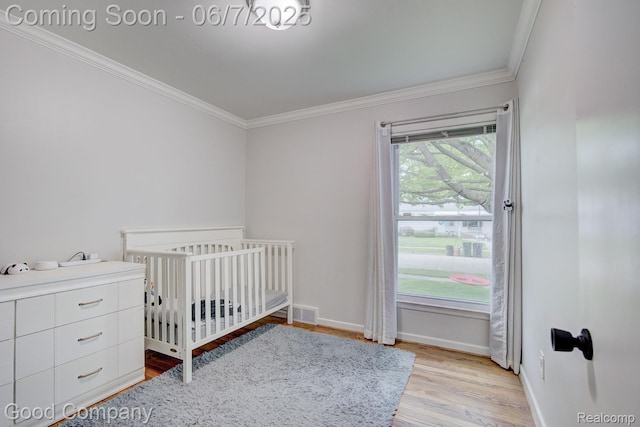 4511 Rosewold Ave, Royal Oak, MI 48073 - bedroom with ornamental molding, a crib, light wood finished floors, and baseboards
