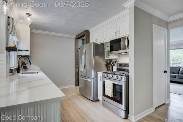4511 Rosewold Ave, Royal Oak, MI 48073 - kitchen with appliances with stainless steel finishes, a sink, light wood-style floors, white cabinets, and baseboards
