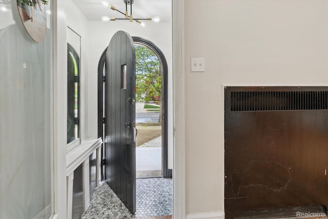 5784 Whittier St, Detroit, MI 48224 - foyer entrance featuring a chandelier, baseboards, and radiator