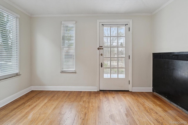 5784 Whittier St, Detroit, MI 48224 - doorway featuring light wood-style floors, ornamental molding, and baseboards