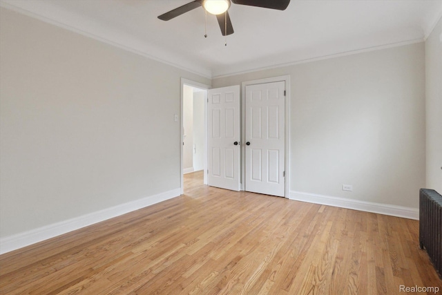 5784 Whittier St, Detroit, MI 48224 - unfurnished bedroom with baseboards, light wood-type flooring, ceiling fan, crown molding, and radiator
