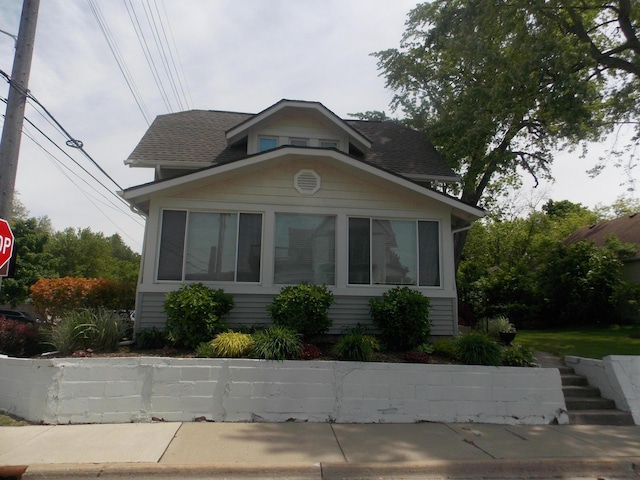 350 N Broadway St, Lake Orion, MI 48362 - view of front of home featuring a sunroom and a shingled roof
