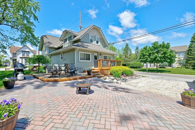 350 N Broadway St, Lake Orion, MI 48362 - back of house with a fire pit, a wooden deck, and a patio area