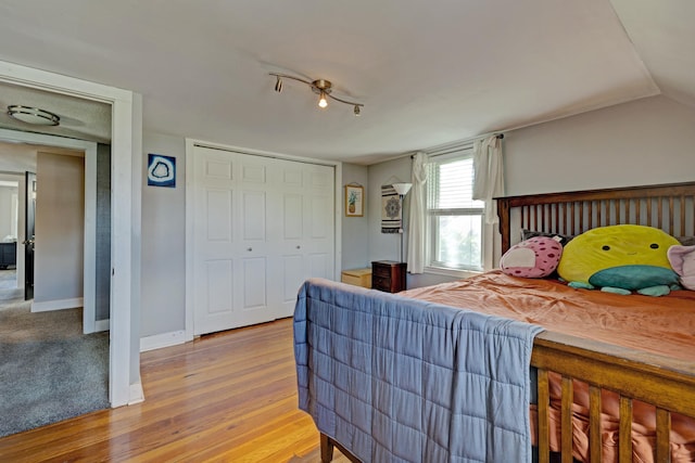 350 N Broadway St, Lake Orion, MI 48362 - bedroom featuring baseboards, a closet, and wood finished floors
