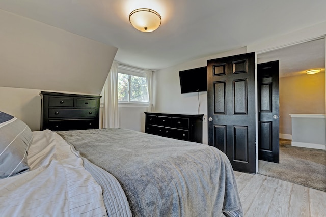 350 N Broadway St, Lake Orion, MI 48362 - bedroom with light wood-type flooring, baseboards, and vaulted ceiling