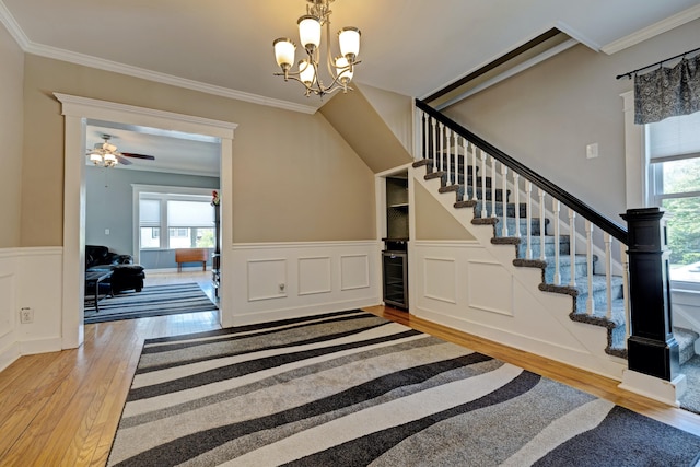 350 N Broadway St, Lake Orion, MI 48362 - staircase featuring hardwood / wood-style floors, crown molding, a wainscoted wall, a chandelier, and ceiling fan