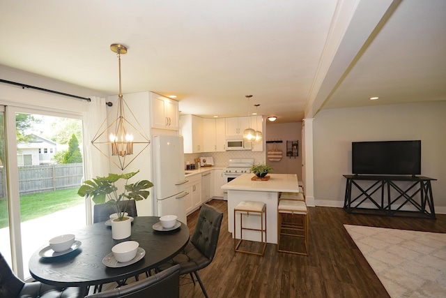 222 S Park St, Zeeland, MI 49464 - dining space with a chandelier, dark wood-type flooring, baseboards, and recessed lighting
