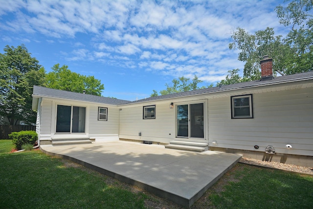 222 S Park St, Zeeland, MI 49464 - back of house featuring a patio, entry steps, a chimney, and a yard