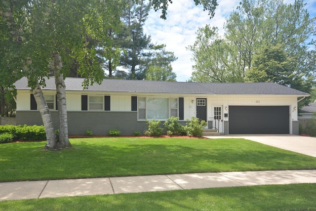 222 S Park St, Zeeland, MI 49464 - ranch-style house with a garage, brick siding, driveway, a front yard, and board and batten siding