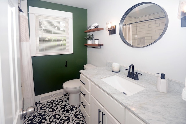 222 S Park St, Zeeland, MI 49464 - full bathroom with vanity, toilet, a shower with curtain, tile patterned flooring, and baseboards