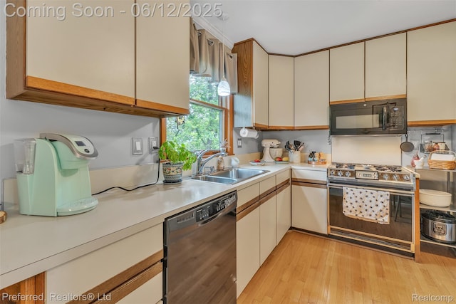 23637 Cranbrooke Dr, Novi, MI 48375 - kitchen featuring black appliances, a sink, light countertops, and light wood finished floors