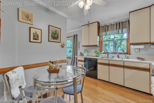 23637 Cranbrooke Dr, Novi, MI 48375 - kitchen with black dishwasher, a sink, light countertops, crown molding, and light wood-type flooring