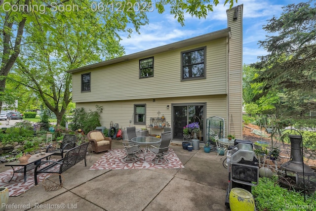 23637 Cranbrooke Dr, Novi, MI 48375 - back of property featuring a patio area and a chimney