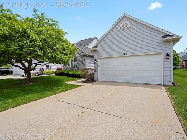 864 Challenging Trl, South Lyon, MI 48178 - view of front of house with a front lawn, concrete driveway, and a garage
