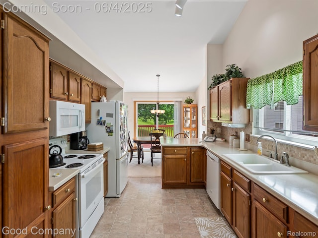 864 Challenging Trl, South Lyon, MI 48178 - kitchen with white appliances, a sink, a peninsula, light countertops, and brown cabinetry