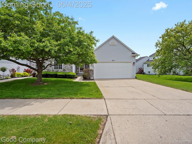 864 Challenging Trl, South Lyon, MI 48178 - obstructed view of property with a front lawn, concrete driveway, stone siding, and a garage