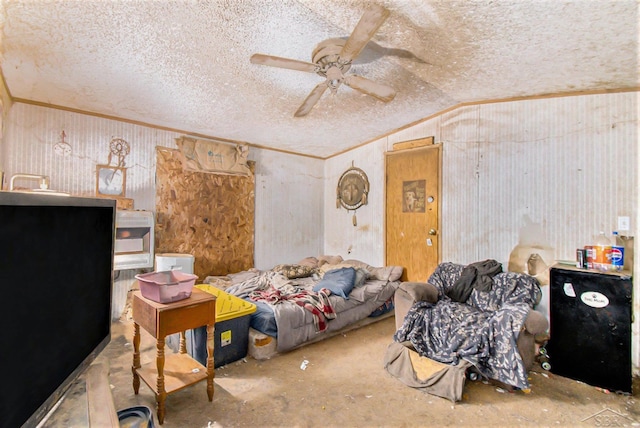 8305 Goodwin Rd, Lyons, MI 48851 - living area with ornamental molding, a ceiling fan, a textured ceiling, lofted ceiling, and wooden walls