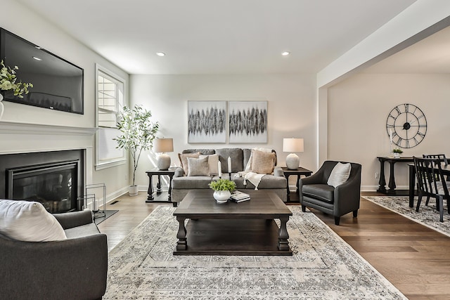 3099 Millbury Ln, Ann Arbor, MI 48105 - living room with recessed lighting, wood finished floors, a glass covered fireplace, and baseboards