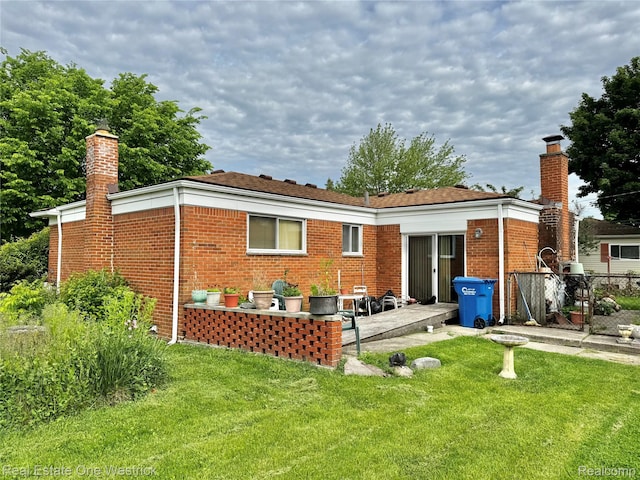 32008 Bunert Rd, Warren, MI 48088 - rear view of house with a chimney, a patio area, and brick siding