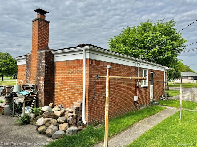 32008 Bunert Rd, Warren, MI 48088 - view of side of property featuring brick siding and a chimney