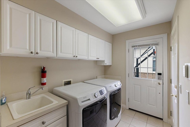 998 Eagle Ave, Ann Arbor, MI 48103 - laundry room featuring cabinet space, washer and dryer, light tile patterned floors, and baseboards