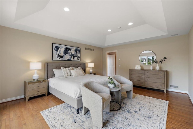 998 Eagle Ave, Ann Arbor, MI 48103 - bedroom featuring a tray ceiling, baseboards, wood finished floors, and recessed lighting