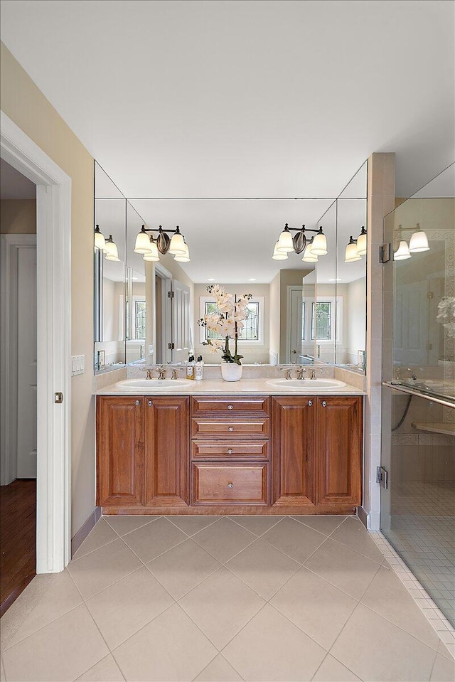 998 Eagle Ave, Ann Arbor, MI 48103 - bathroom with double vanity, tile patterned flooring, and a stall shower