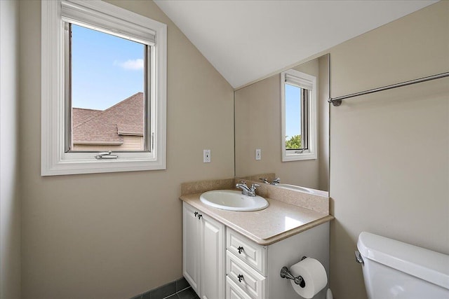 998 Eagle Ave, Ann Arbor, MI 48103 - half bathroom with vanity, toilet, and lofted ceiling