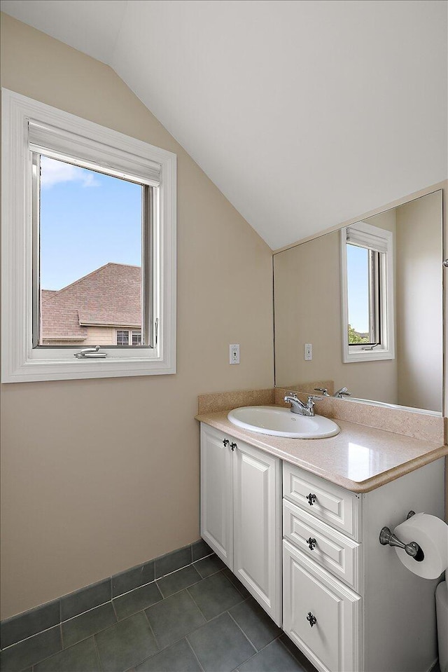 998 Eagle Ave, Ann Arbor, MI 48103 - bathroom with lofted ceiling, vanity, healthy amount of natural light, and tile patterned floors