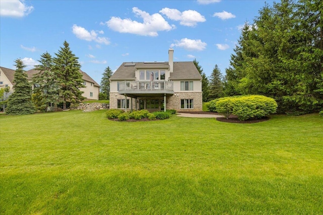 998 Eagle Ave, Ann Arbor, MI 48103 - back of house with a lawn, solar panels, a chimney, and a balcony