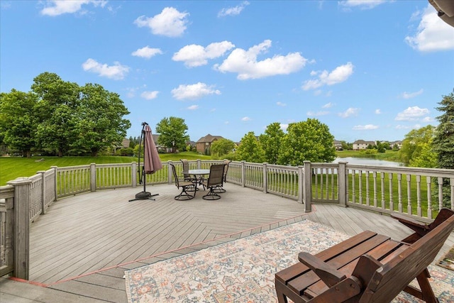 998 Eagle Ave, Ann Arbor, MI 48103 - wooden deck with outdoor dining area, a water view, and a lawn