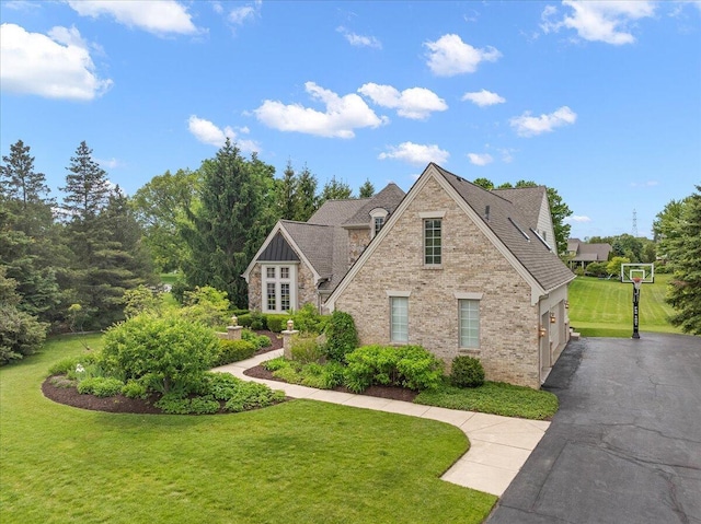 998 Eagle Ave, Ann Arbor, MI 48103 - view of front of house with a front yard, driveway, brick siding, and stone siding