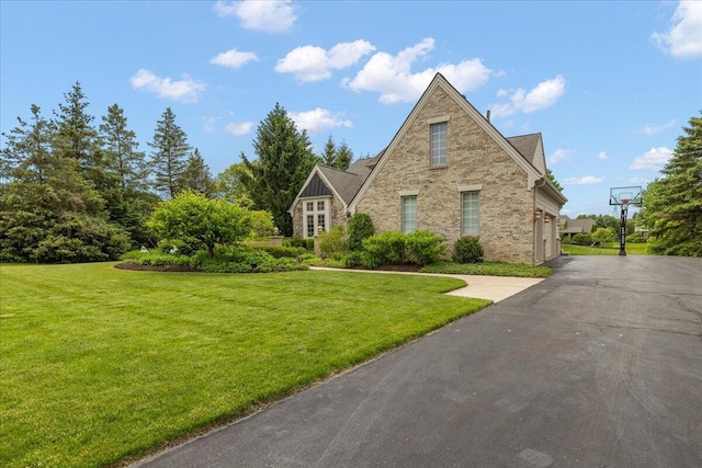 998 Eagle Ave, Ann Arbor, MI 48103 - view of front facade featuring brick siding, a front lawn, a garage, and driveway