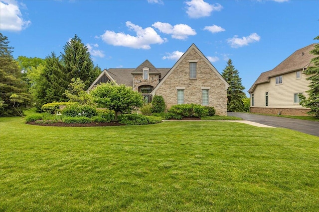 998 Eagle Ave, Ann Arbor, MI 48103 - tudor home with a front yard, brick siding, and stone siding