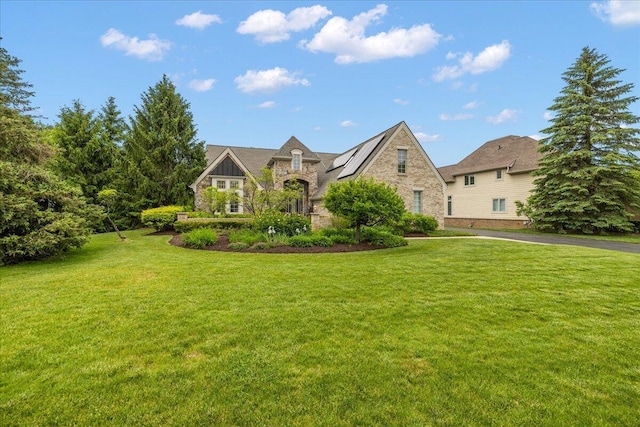 998 Eagle Ave, Ann Arbor, MI 48103 - view of front facade featuring stone siding, a front lawn, and solar panels