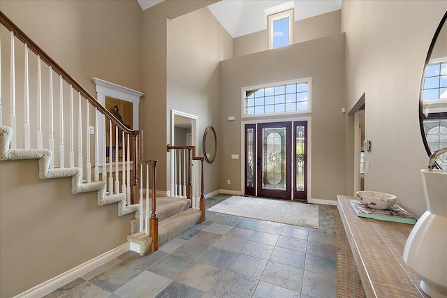 998 Eagle Ave, Ann Arbor, MI 48103 - foyer with a high ceiling, baseboards, plenty of natural light, and stone tile flooring