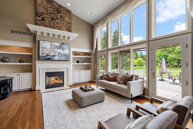 998 Eagle Ave, Ann Arbor, MI 48103 - living room featuring a high ceiling, wood finished floors, a fireplace with flush hearth, healthy amount of natural light, and recessed lighting