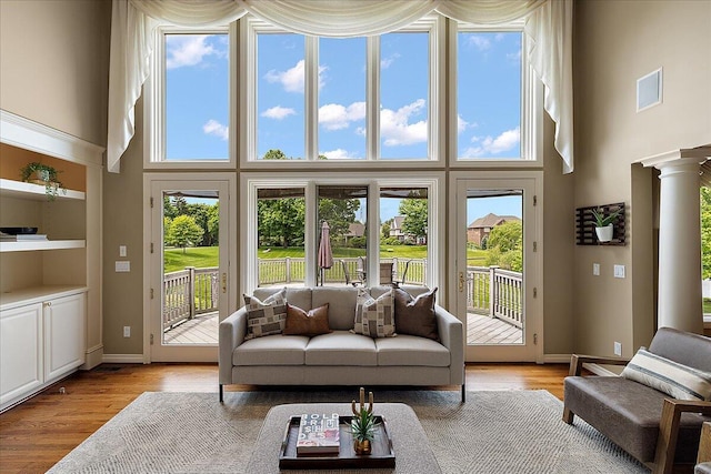 998 Eagle Ave, Ann Arbor, MI 48103 - living area with a towering ceiling, light wood finished floors, and baseboards
