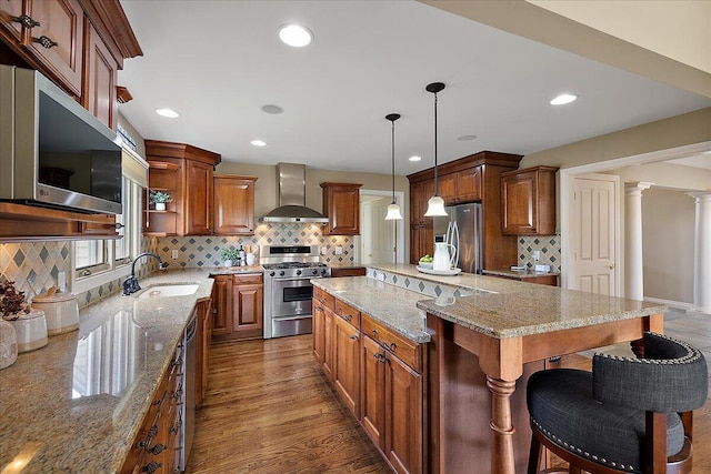 998 Eagle Ave, Ann Arbor, MI 48103 - kitchen featuring stainless steel appliances, wall chimney exhaust hood, a sink, open shelves, and tasteful backsplash