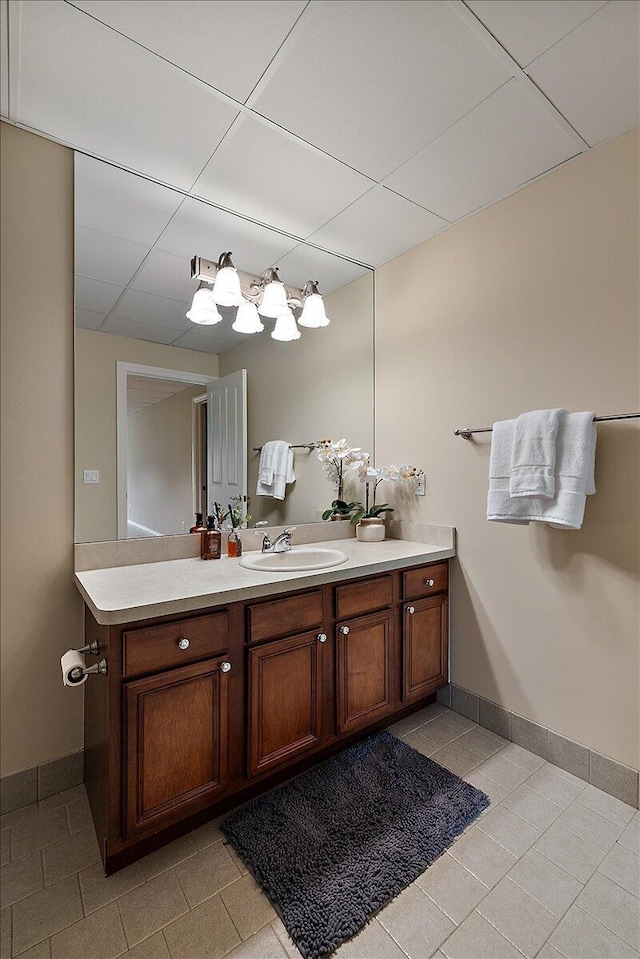 998 Eagle Ave, Ann Arbor, MI 48103 - bathroom featuring vanity, tile patterned floors, baseboards, and a paneled ceiling