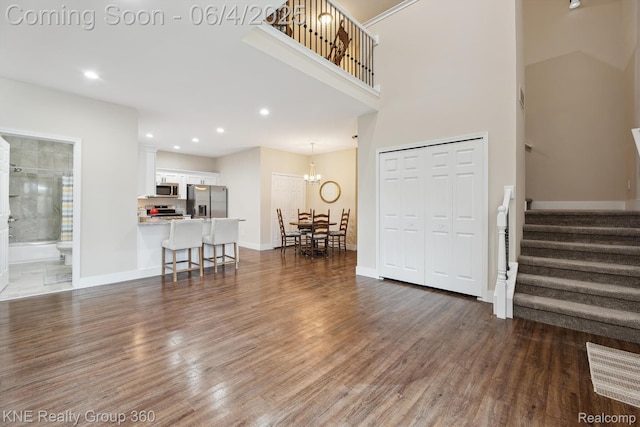 1720 Carlisle St, Howell, MI 48855 - living room featuring stairway, wood finished floors, baseboards, recessed lighting, and a chandelier