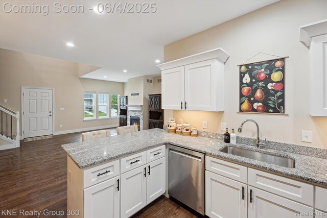 1720 Carlisle St, Howell, MI 48855 - kitchen with dishwasher, a sink, a peninsula, dark wood-style flooring, and white cabinetry