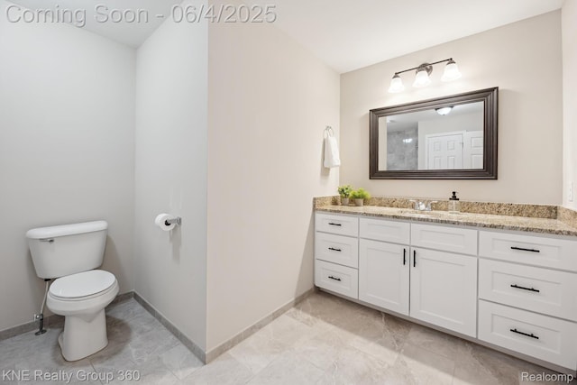 1720 Carlisle St, Howell, MI 48855 - bathroom with vanity, toilet, and baseboards