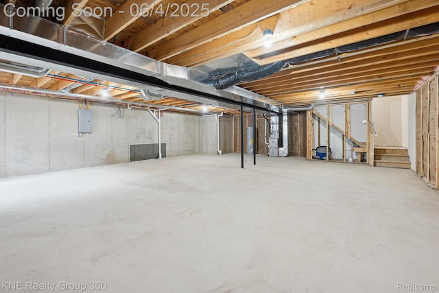 1720 Carlisle St, Howell, MI 48855 - unfinished basement featuring electric panel, electric water heater, stairway, and heating unit